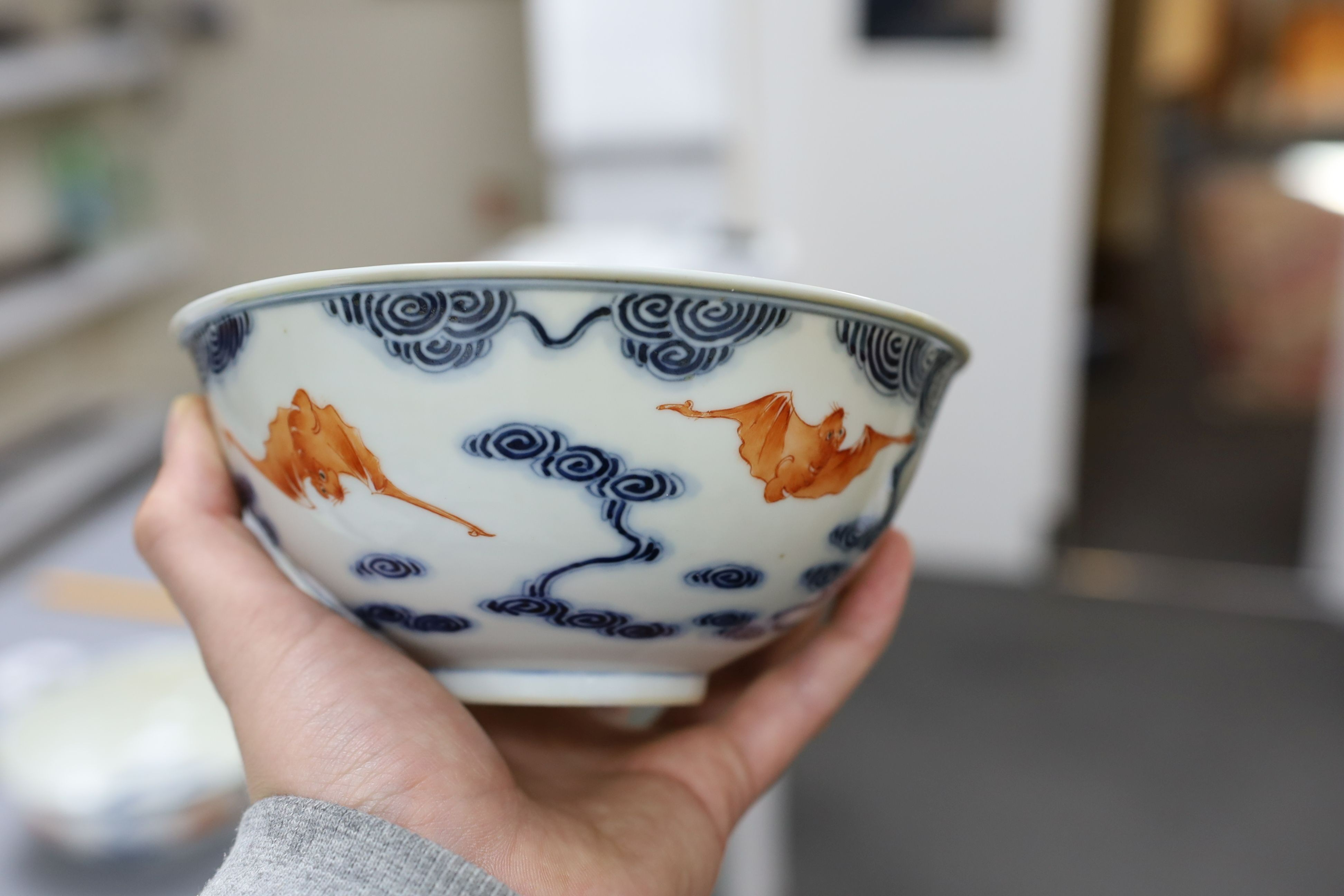 A pair of Chinese iron red and underglaze blue ‘five bat’ bowls, Guangxu mark and probably of the period (1875-1908), 16.5cm diameter